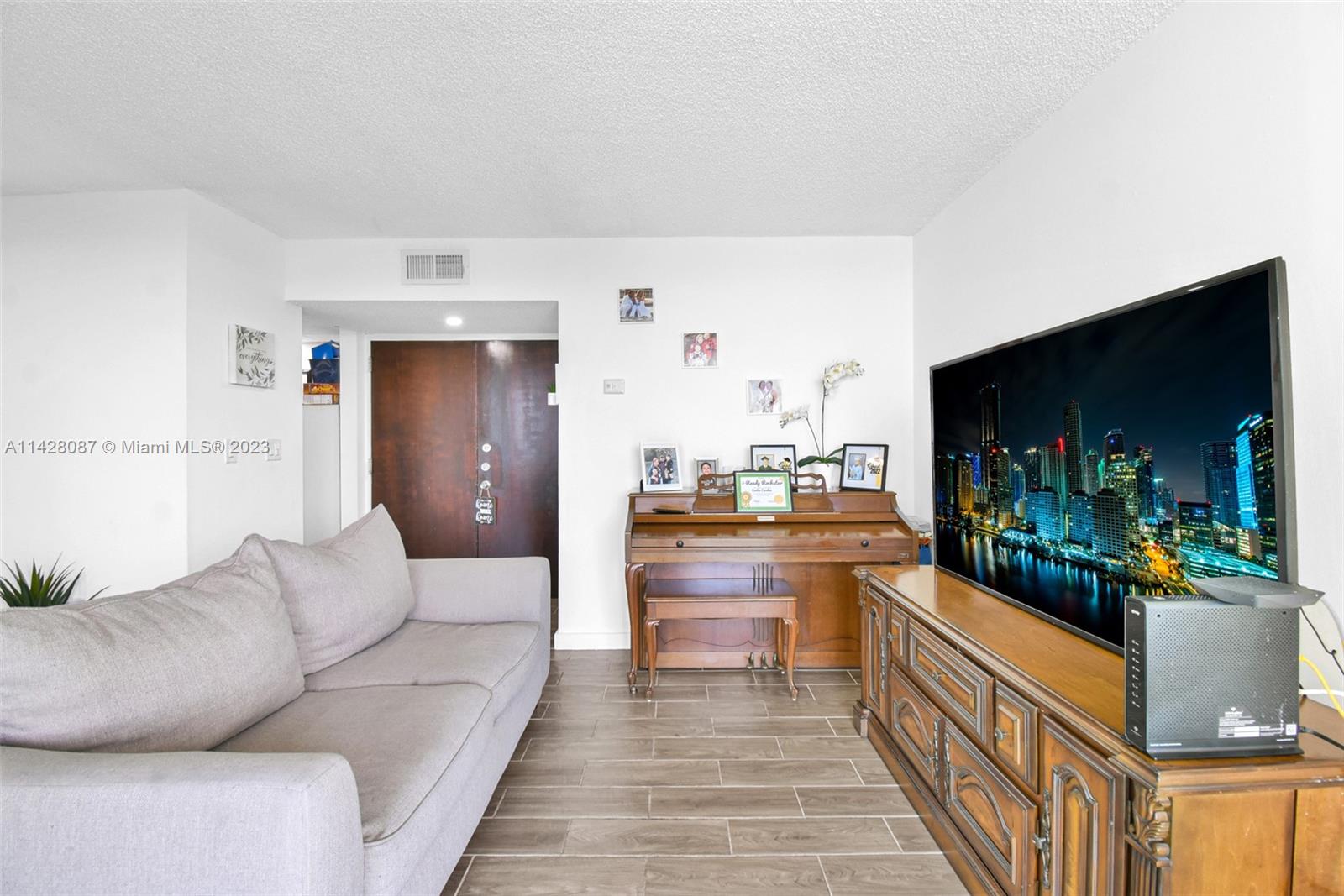 11800 Southwest 18th Street, Unit 5084 Miami, FL 33175 - Photo 11 of 44 a living room with furniture and a flat screen tv