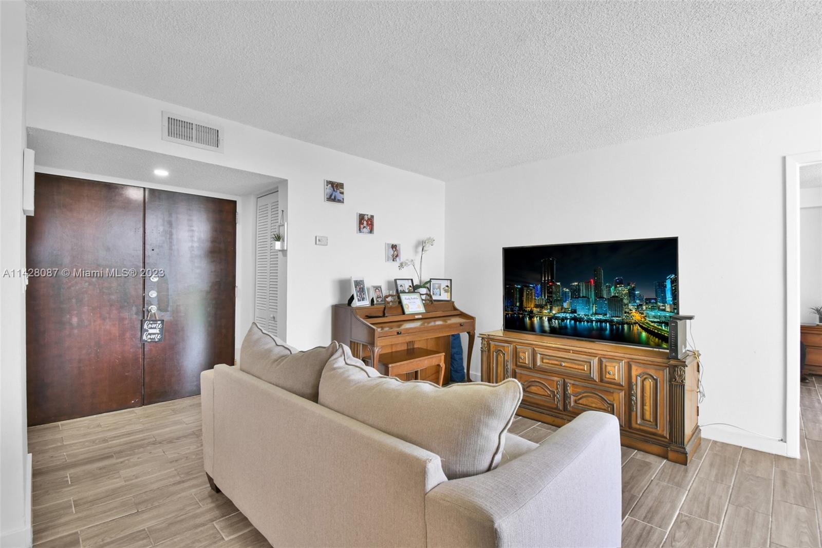 11800 Southwest 18th Street, Unit 5084 Miami, FL 33175 - Photo 13 of 44 a living room with furniture and a flat screen tv