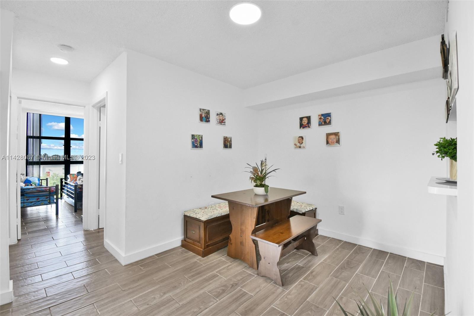 11800 Southwest 18th Street, Unit 5084 Miami, FL 33175 - Photo 16 of 44 a view of a workspace with wooden floor and a potted plant