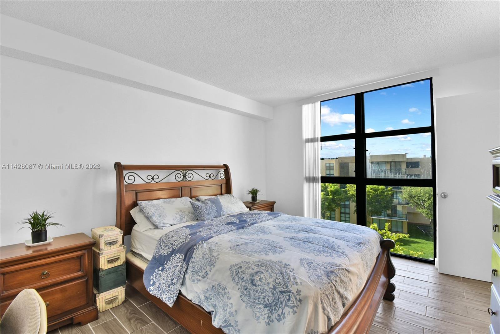 11800 Southwest 18th Street, Unit 5084 Miami, FL 33175 - Photo 17 of 44 a bedroom with a bed and a large window