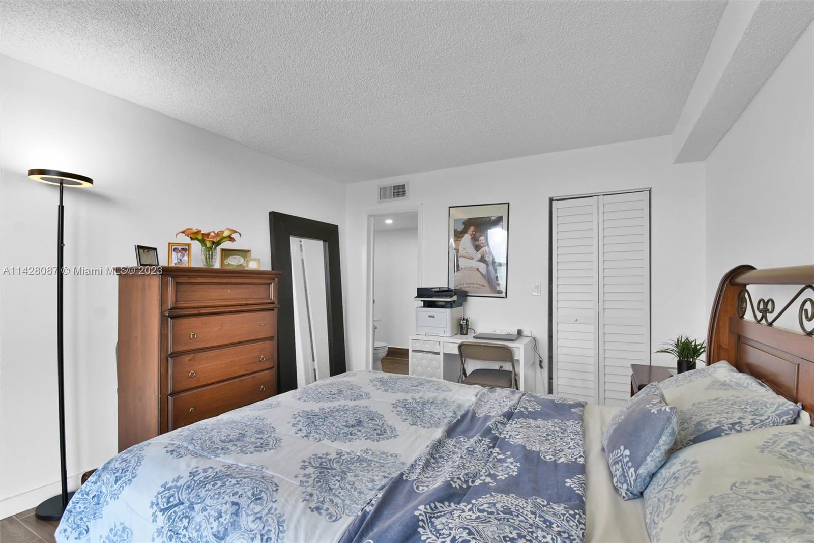 11800 Southwest 18th Street, Unit 5084 Miami, FL 33175 - Photo 19 of 44 a bedroom with a bed and wooden floor