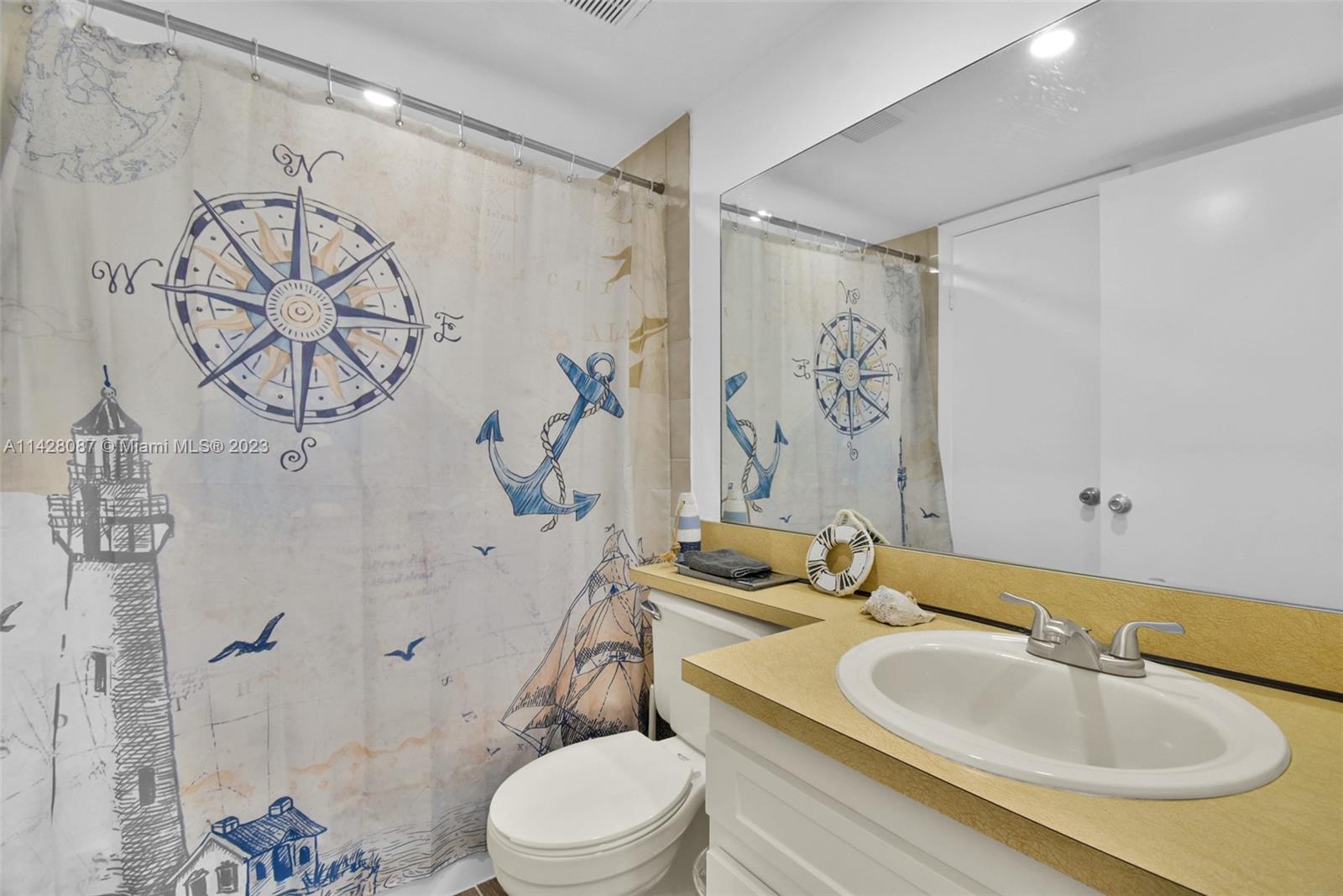 11800 Southwest 18th Street, Unit 5084 Miami, FL 33175 - Photo 24 of 44 a bathroom with a sink a toilet and shower