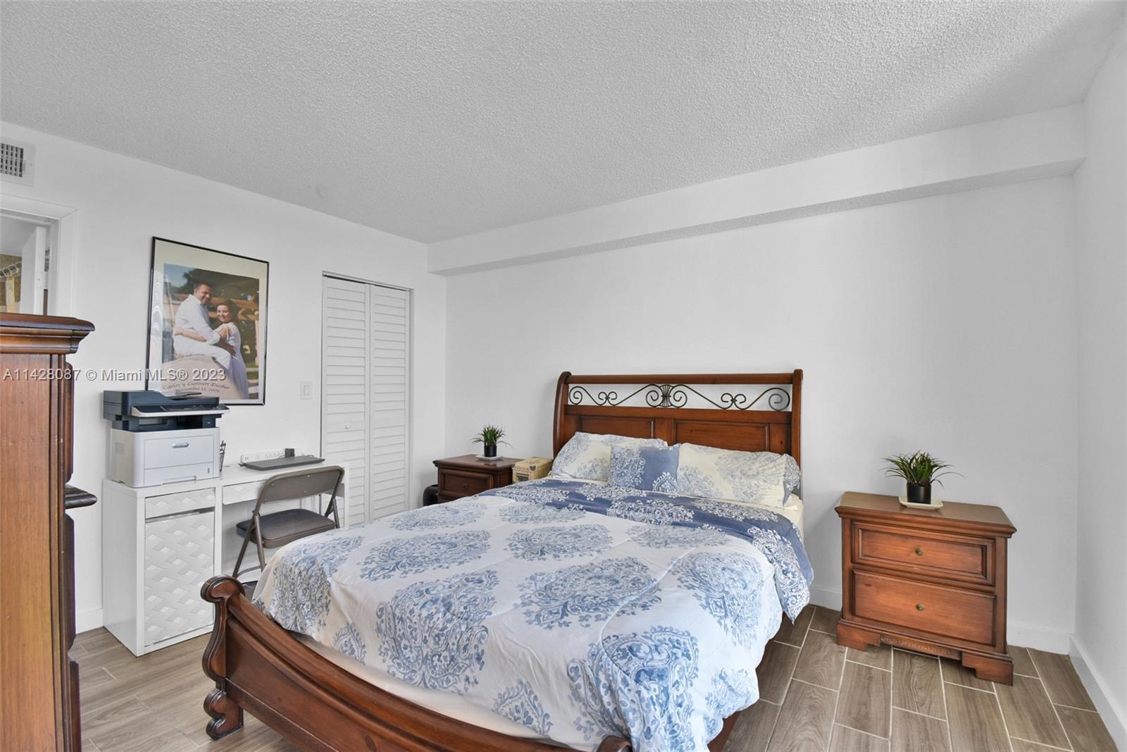11800 Southwest 18th Street, Unit 5084 Miami, FL 33175 - Photo 3 of 44 a bedroom with a bed and wooden floor