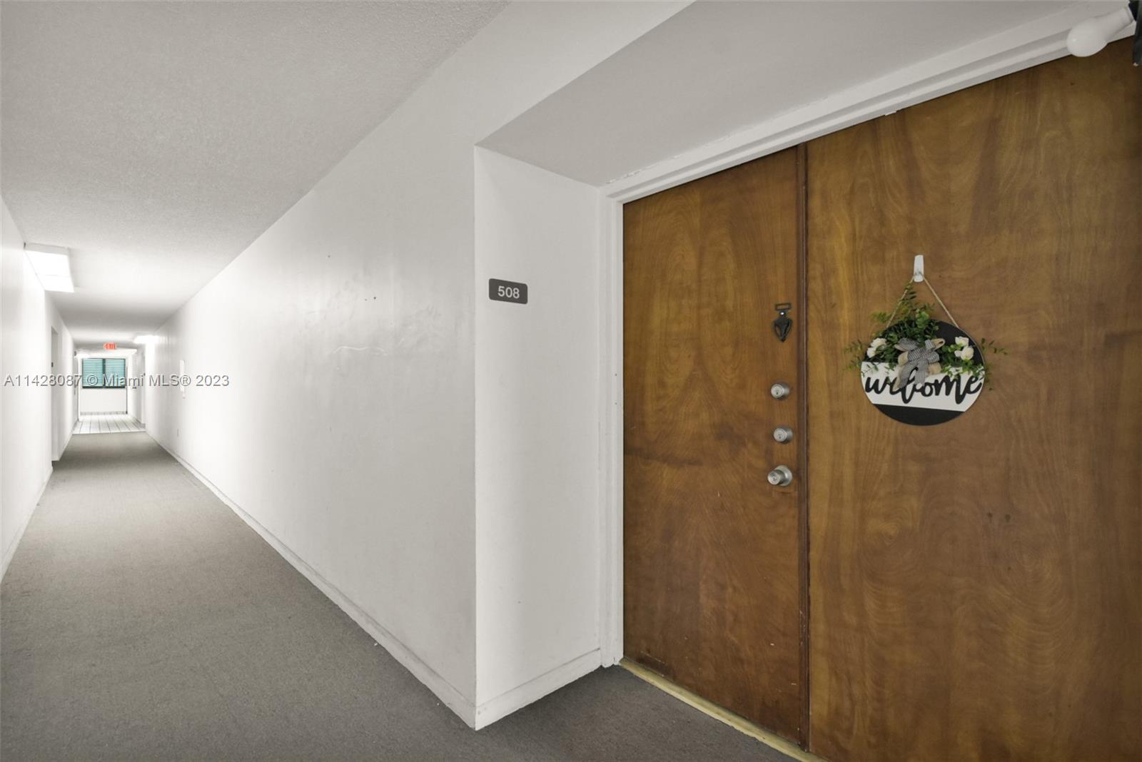 11800 Southwest 18th Street, Unit 5084 Miami, FL 33175 - Photo 33 of 44 a view of a hallway with wooden shelves