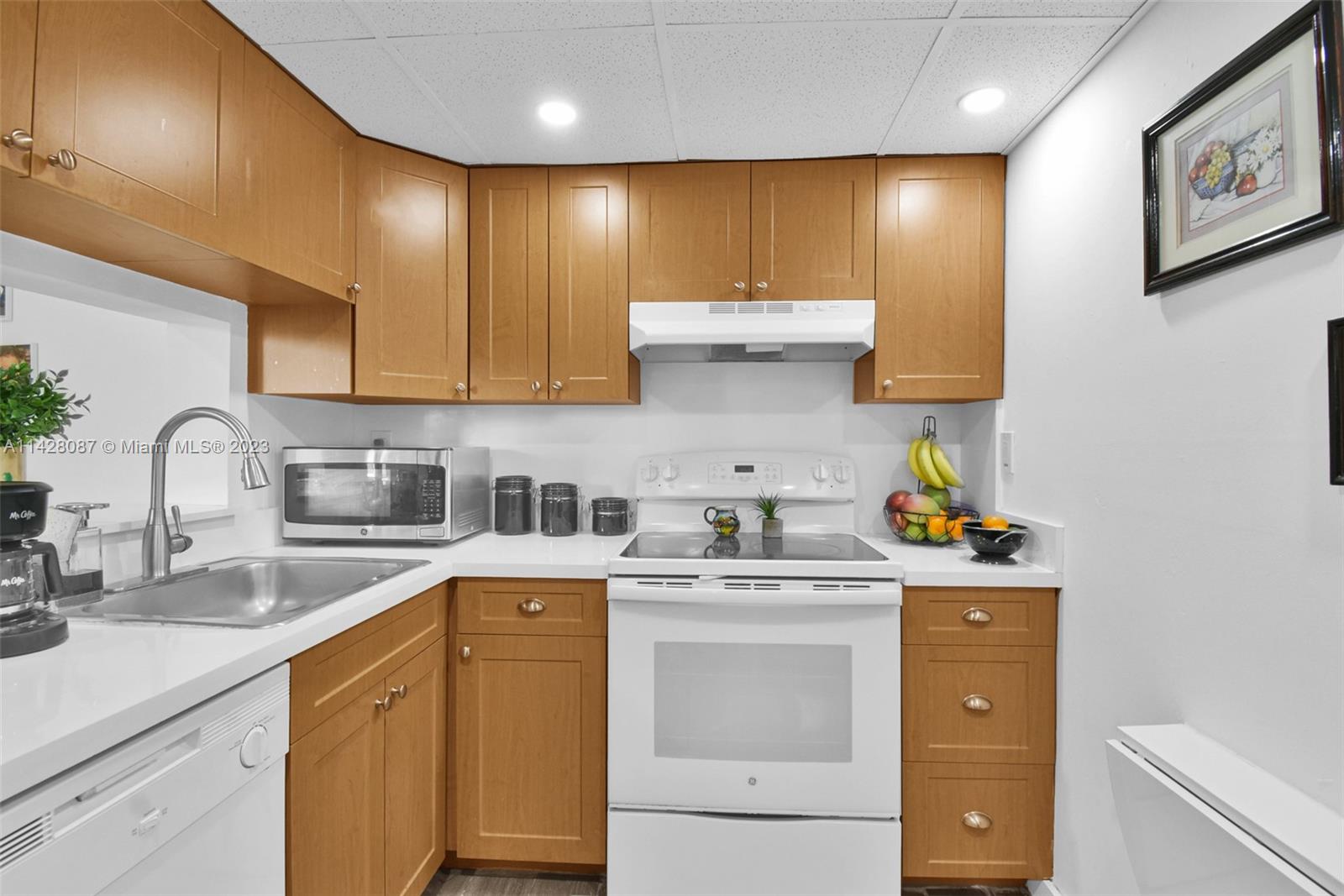 11800 Southwest 18th Street, Unit 5084 Miami, FL 33175 - Photo 8 of 44 a kitchen with stainless steel appliances granite countertop a sink a stove and cabinets
