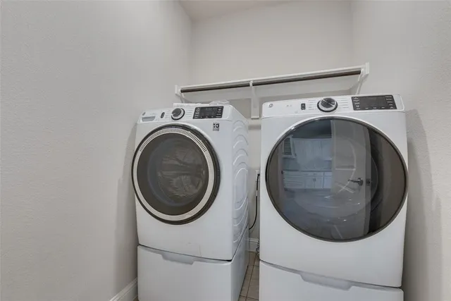 a kitchen with granite countertop white cabinets and stainless steel appliances