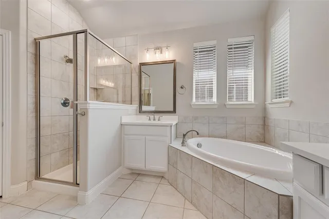 a bathroom with a tub sink and mirror