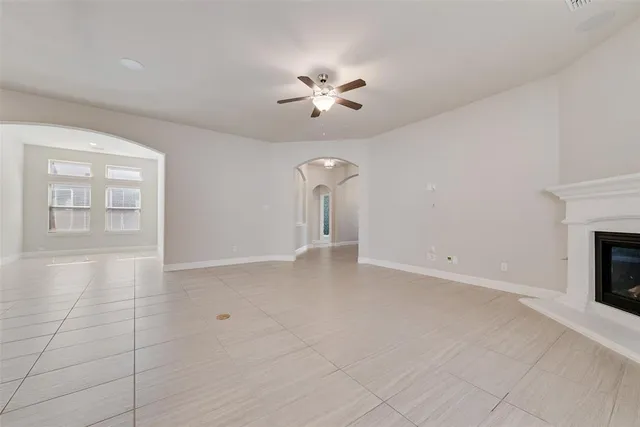 wooden floor in an empty room with a fireplace