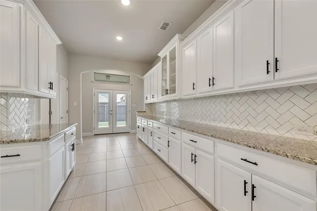 a large kitchen with stainless steel appliances granite countertop a stove and a sink