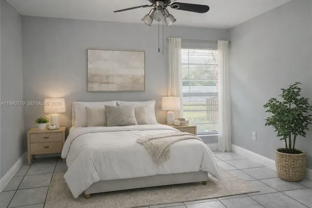 a bedroom with a bed and a potted plant