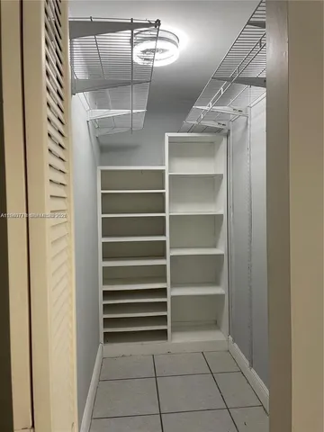 a view of walk in closet with empty racks