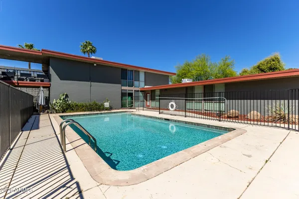 swimming pool view with a seating space