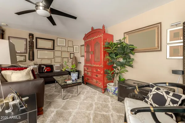 a living room with furniture and a potted plant