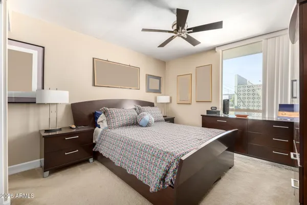 a bedroom with a large bed and a chandelier