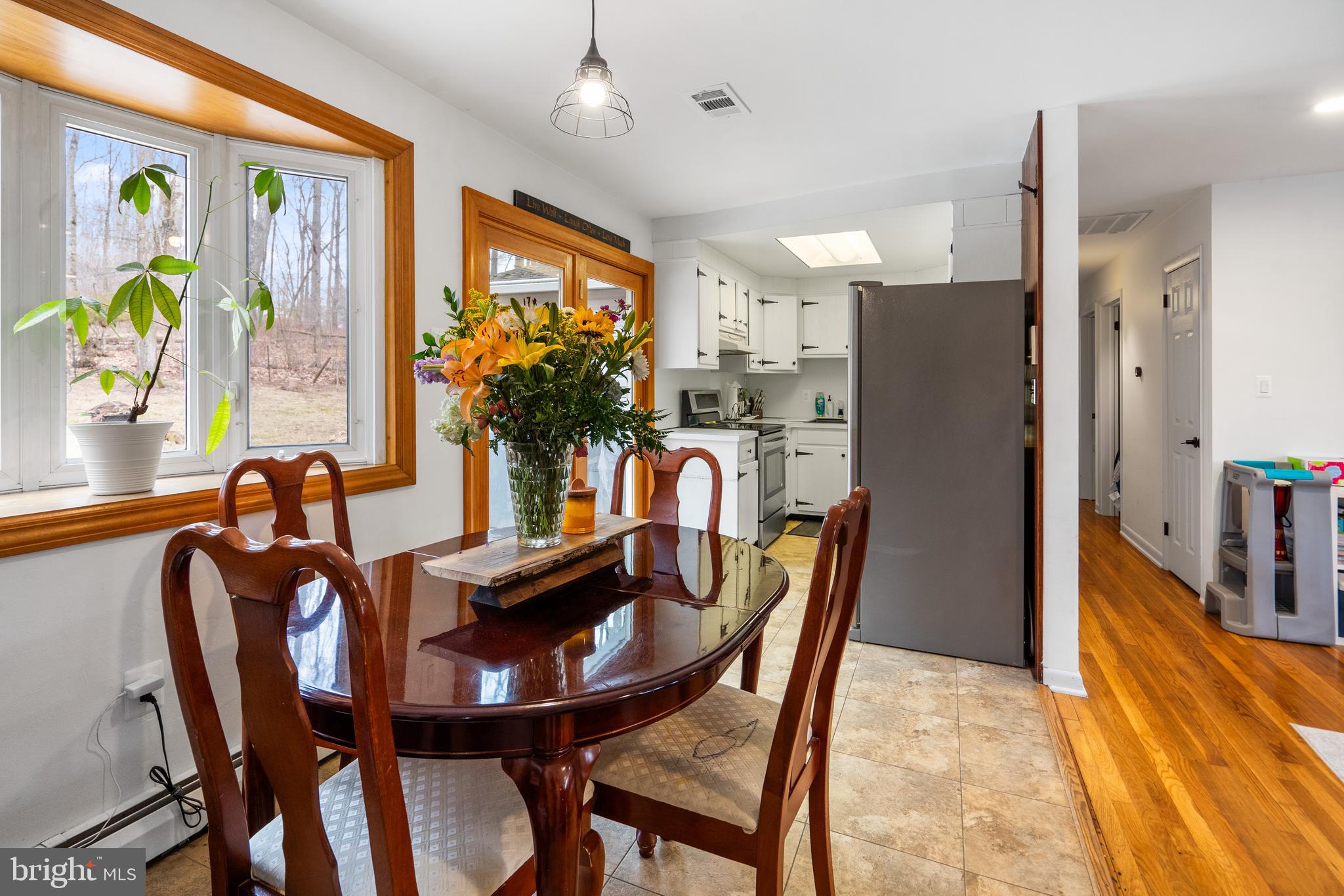3605 Hoffman Mill Road Hampstead, MD 21074 - Photo 12 of 43 a view of a dining room with furniture one side kitchen view and wooden floor