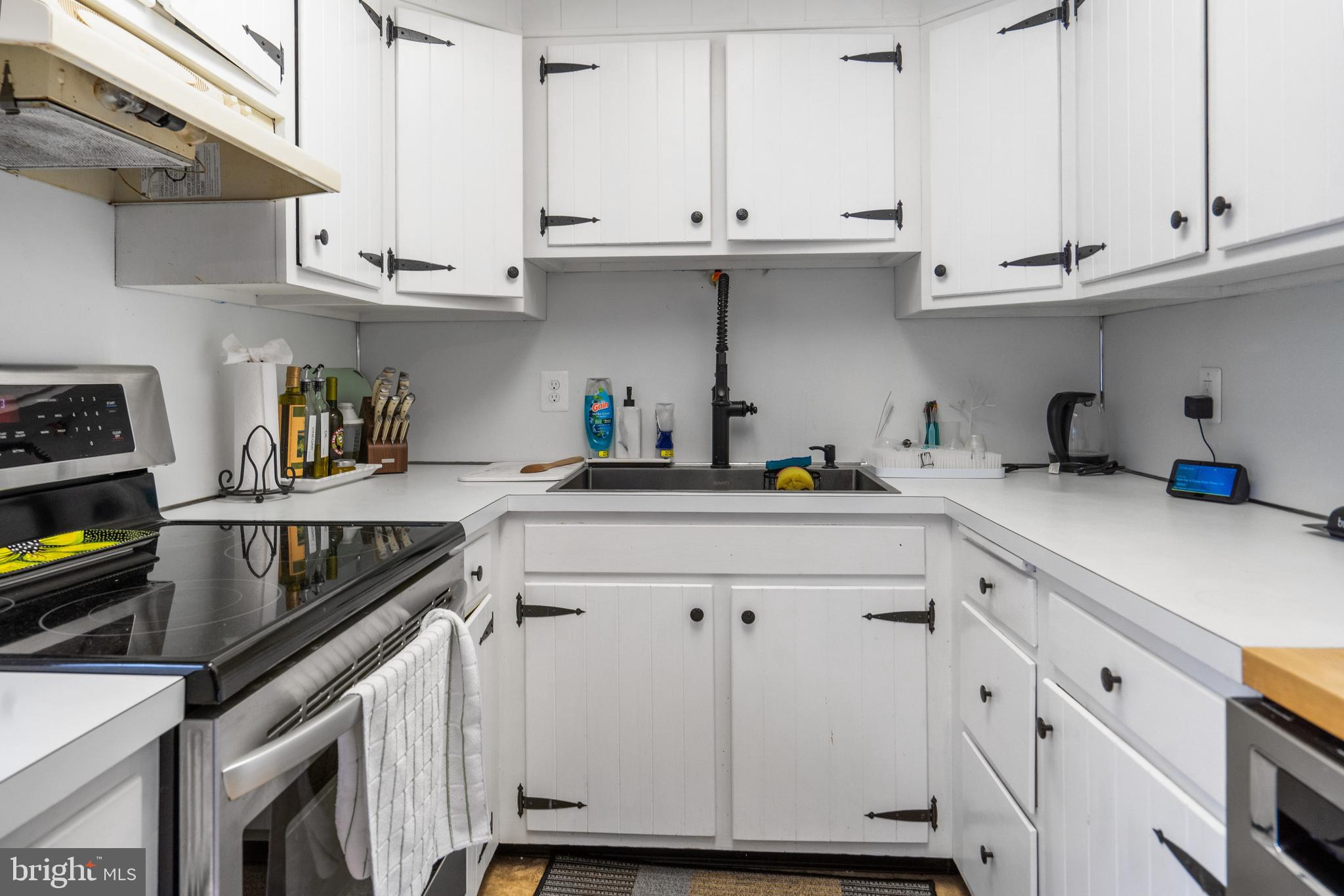 3605 Hoffman Mill Road Hampstead, MD 21074 - Photo 13 of 43 a kitchen with granite countertop white cabinets and a sink