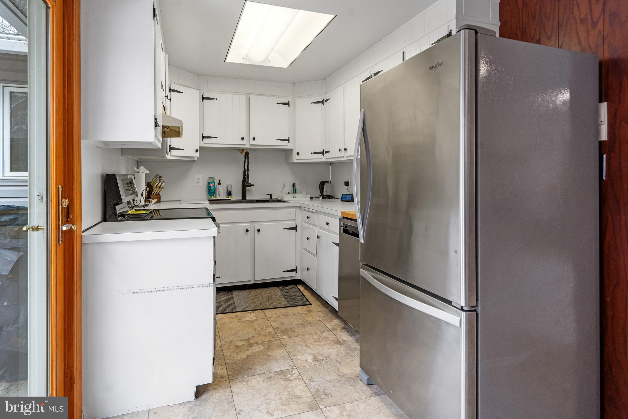 3605 Hoffman Mill Road Hampstead, MD 21074 - Photo 14 of 43 a kitchen with a refrigerator sink and cabinets