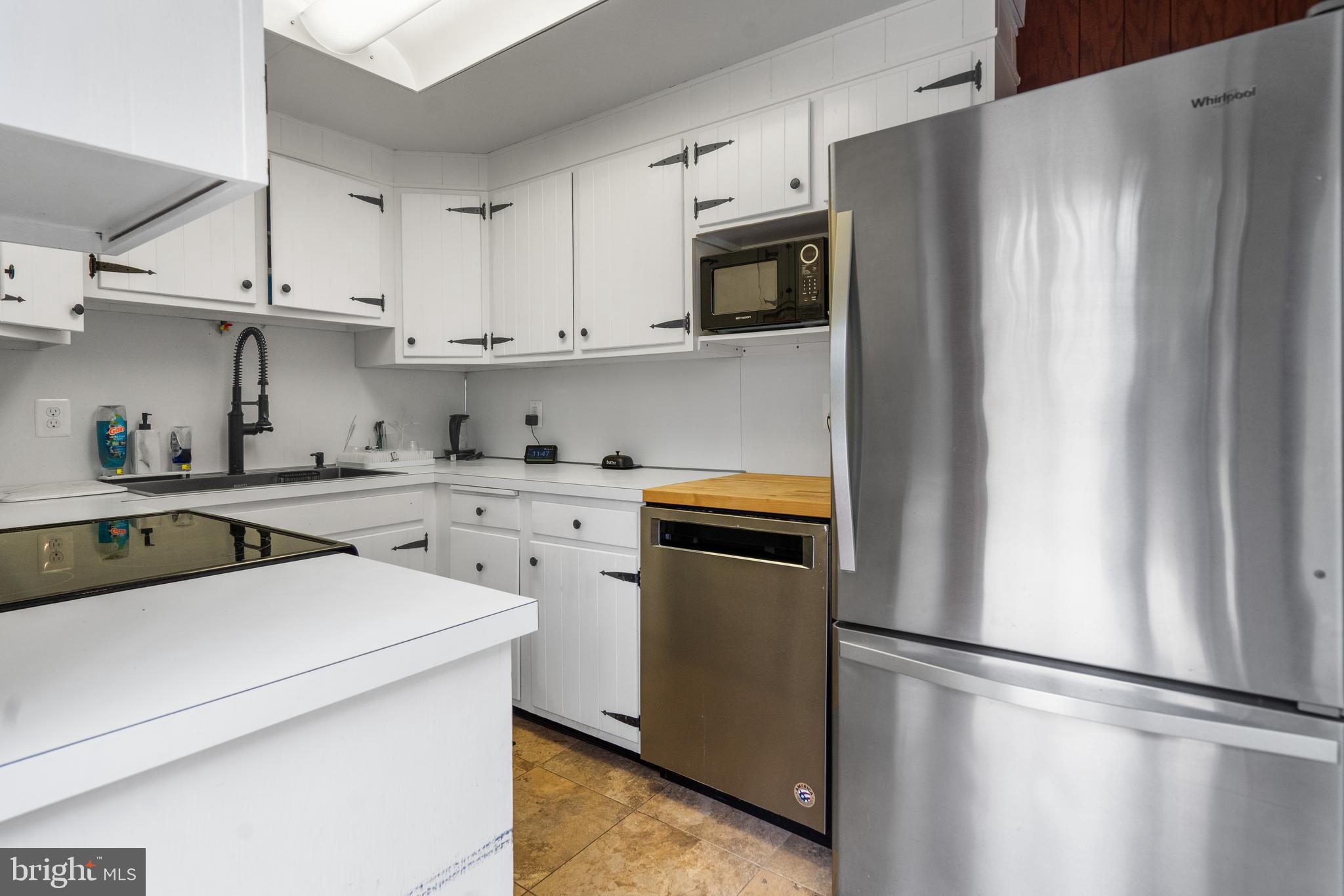 3605 Hoffman Mill Road Hampstead, MD 21074 - Photo 15 of 43 a kitchen with a refrigerator sink and white cabinets