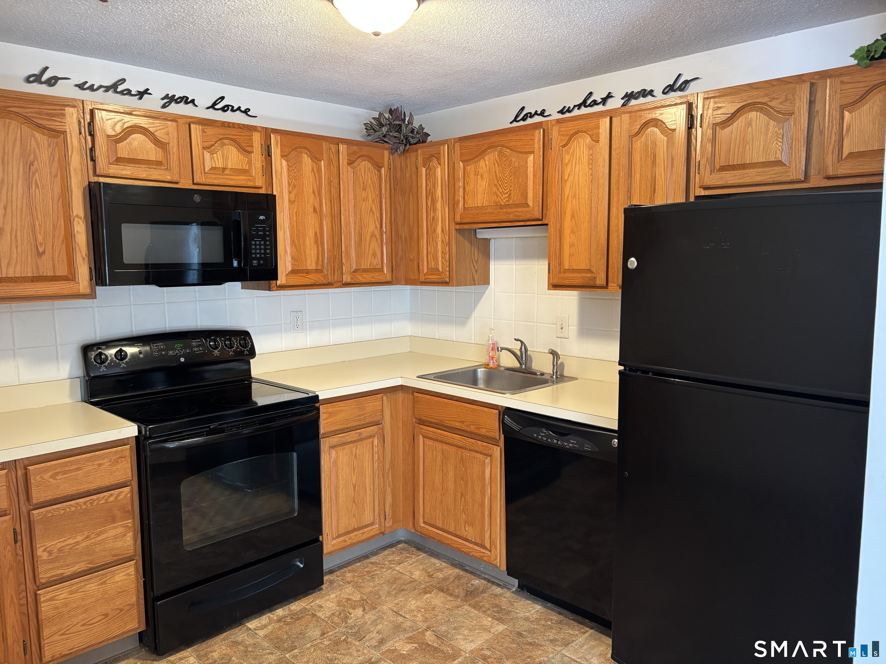16 Putter Drive, Unit 207S Wallingford, CT 06492 - Photo 2 of 15 a kitchen with granite countertop a refrigerator stove and microwave
