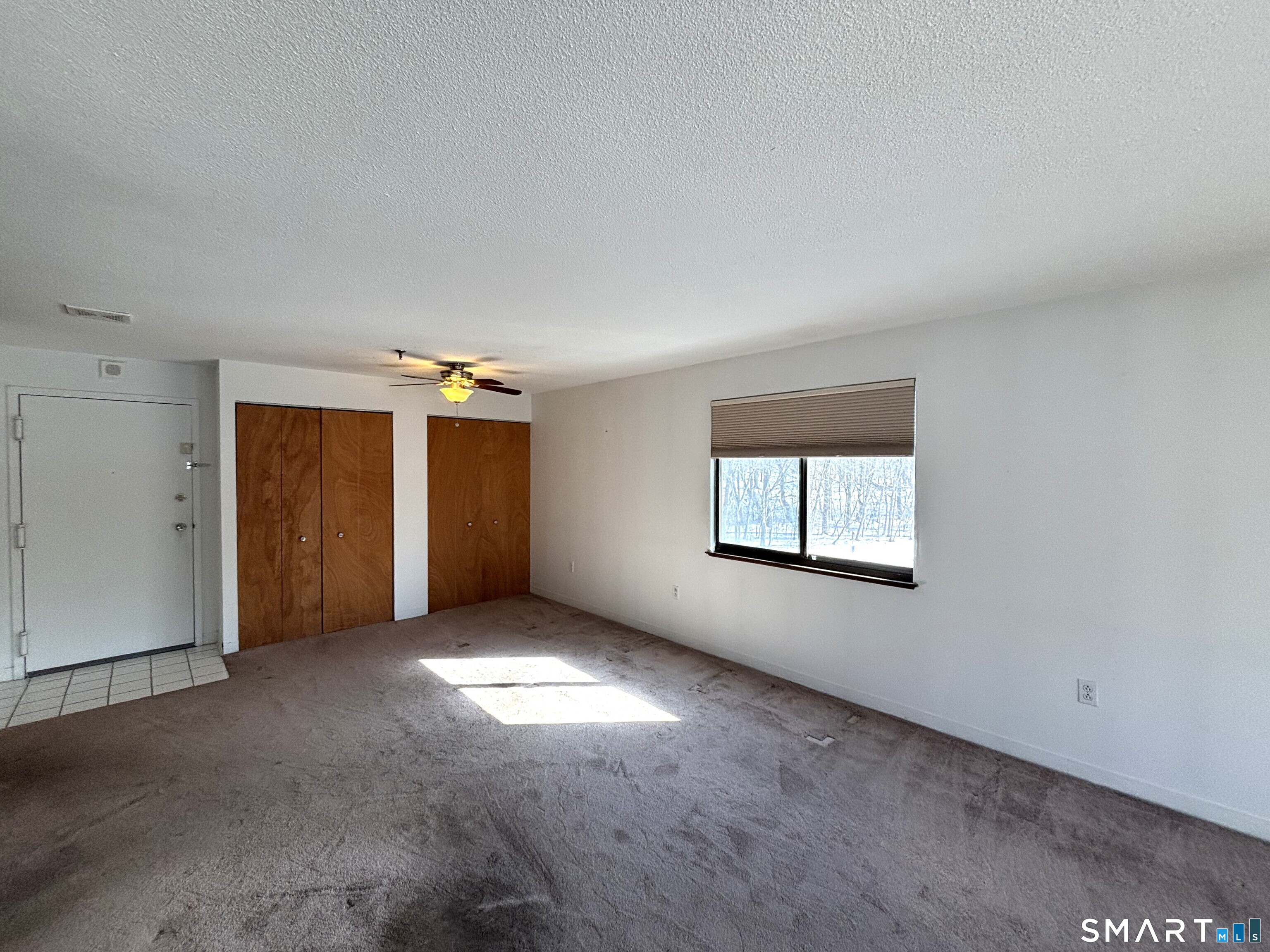16 Putter Drive, Unit 207S Wallingford, CT 06492 - Photo 5 of 15 an empty room with windows