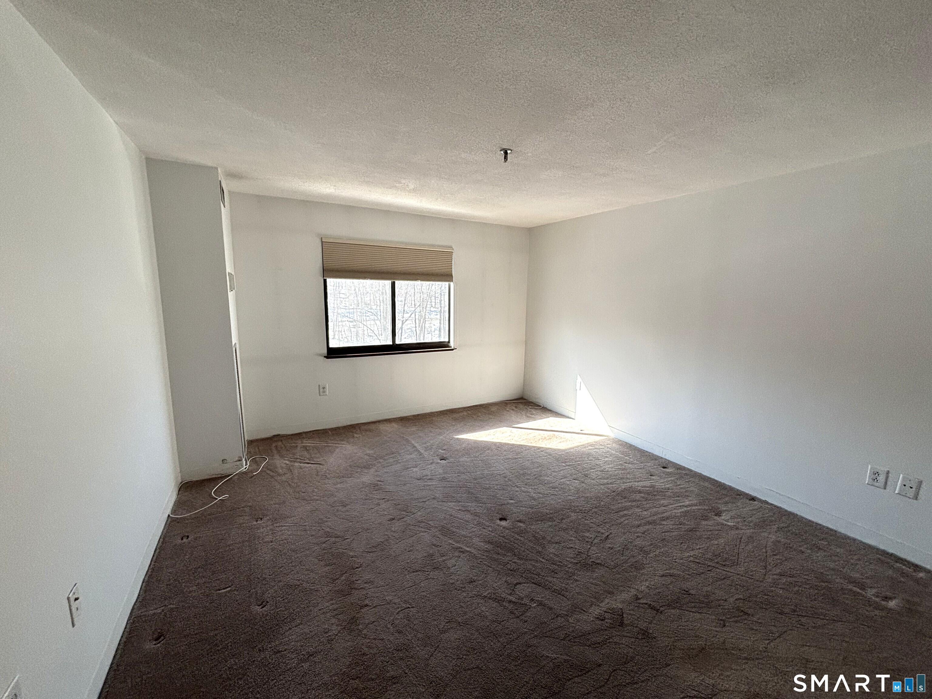 16 Putter Drive, Unit 207S Wallingford, CT 06492 - Photo 8 of 15 an empty room with a empty space and windows