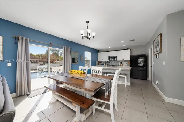 a kitchen with a sink and chairs