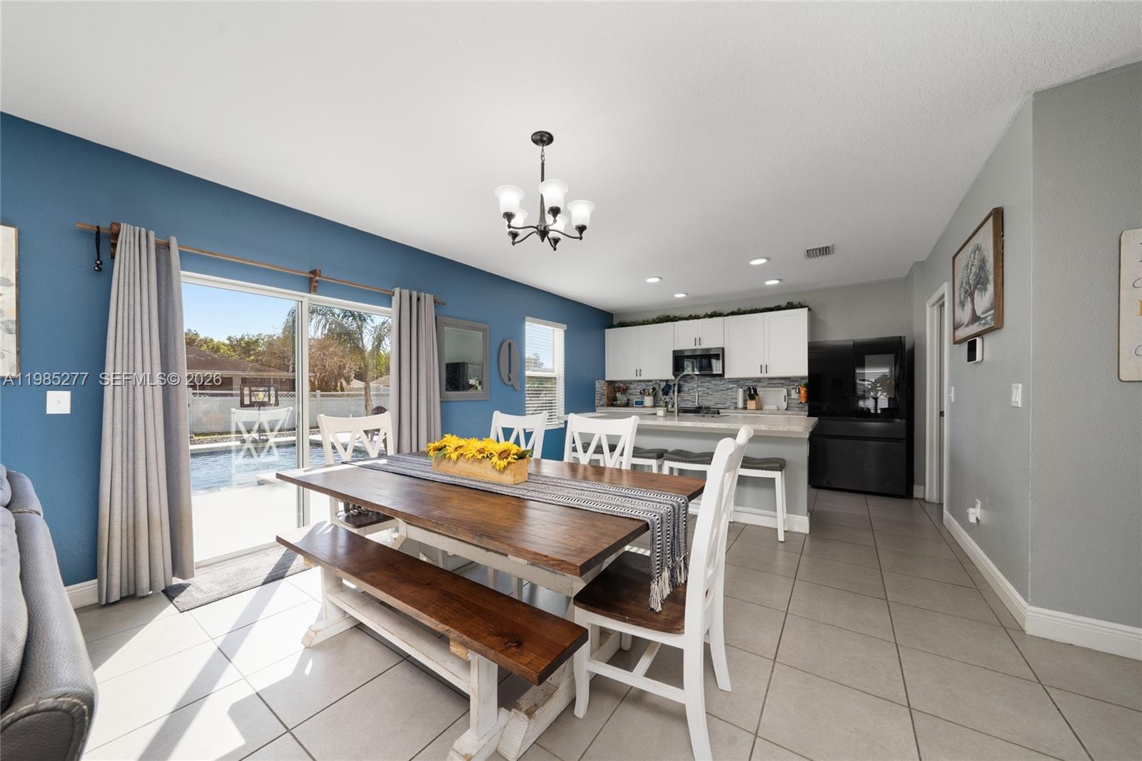 2824 Northeast 43rd Road Ocala, FL 34470 - Photo 13 of 45 a kitchen with a sink and chairs