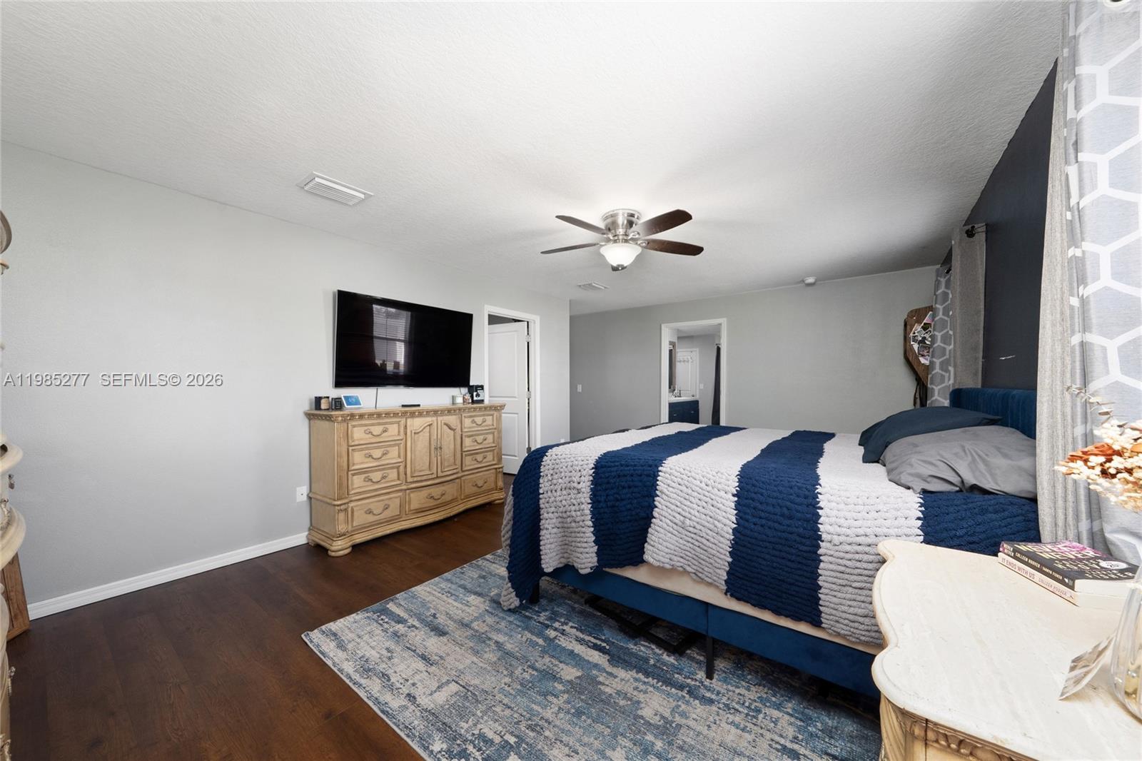 2824 Northeast 43rd Road Ocala, FL 34470 - Photo 17 of 45 a bedroom with a bed and a flat screen tv