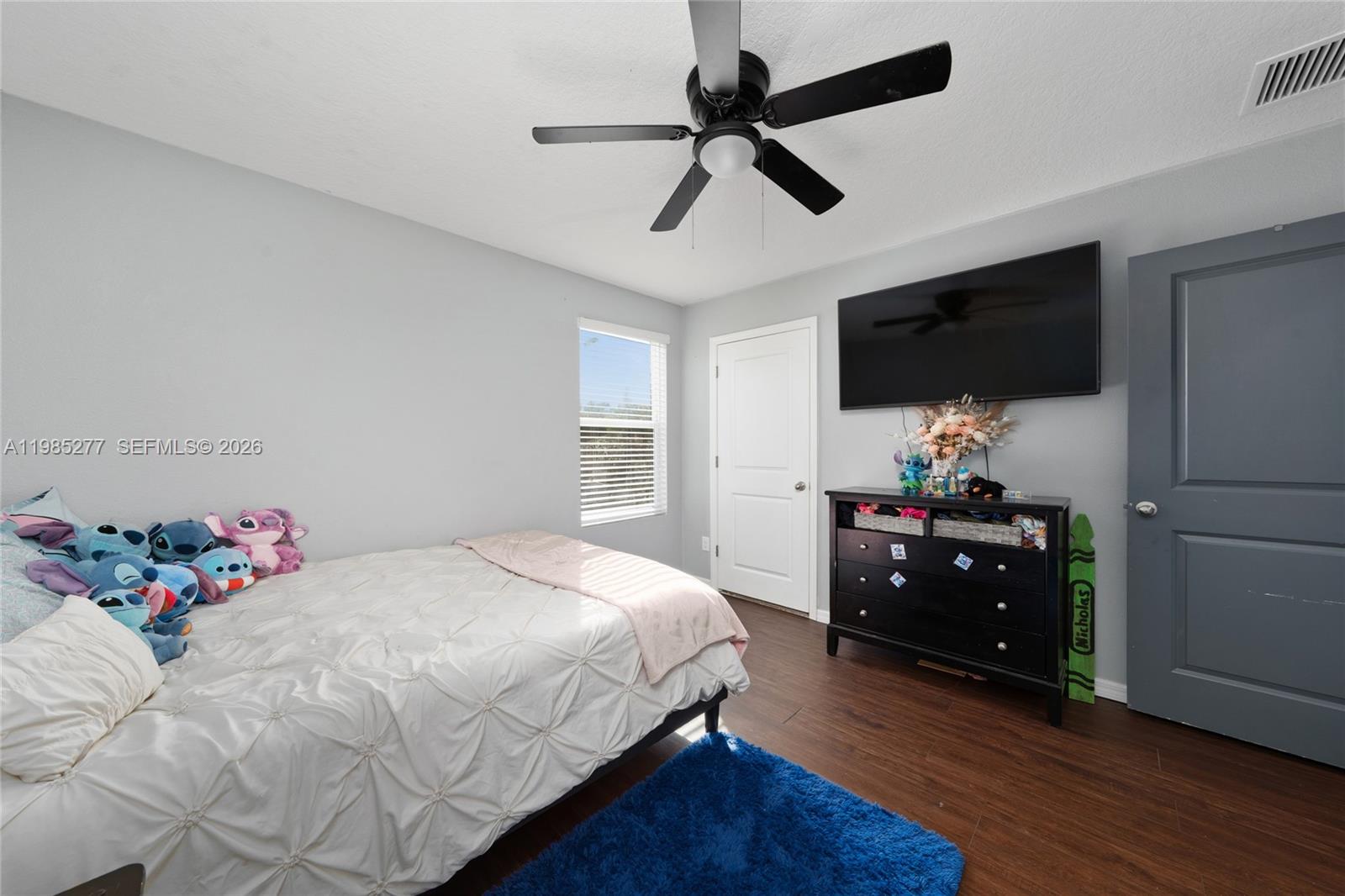 2824 Northeast 43rd Road Ocala, FL 34470 - Photo 25 of 45 a bedroom with a bed and a flat screen tv