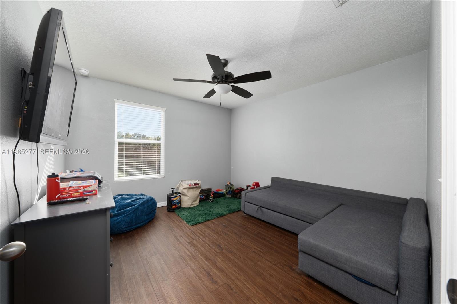 2824 Northeast 43rd Road Ocala, FL 34470 - Photo 26 of 45 a living room with furniture and a flat screen tv