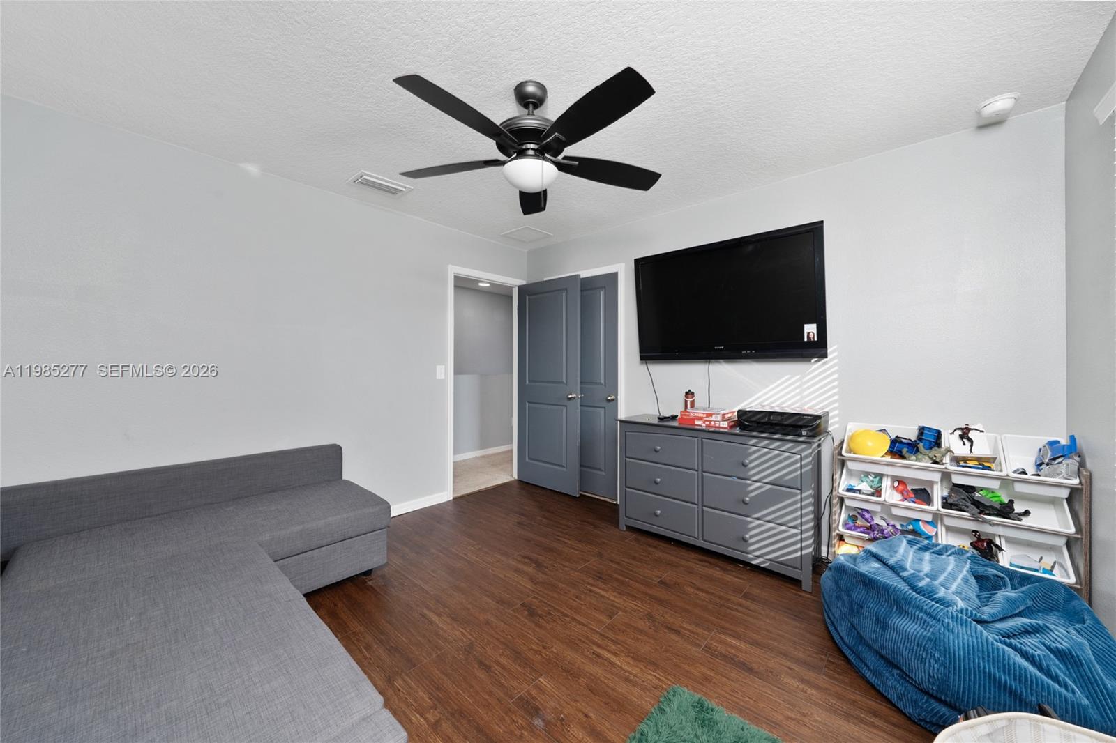 2824 Northeast 43rd Road Ocala, FL 34470 - Photo 27 of 45 a living room with furniture and a flat screen tv