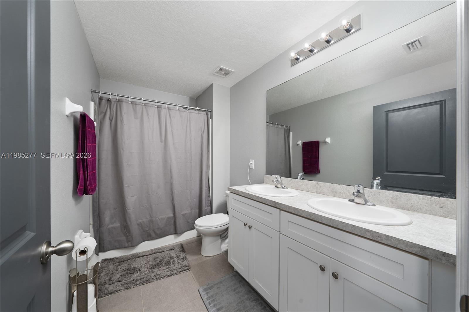 2824 Northeast 43rd Road Ocala, FL 34470 - Photo 28 of 45 a bathroom with a sink a toilet and shower