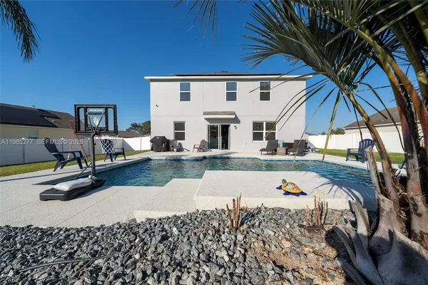 a view of backyard of house with seating space