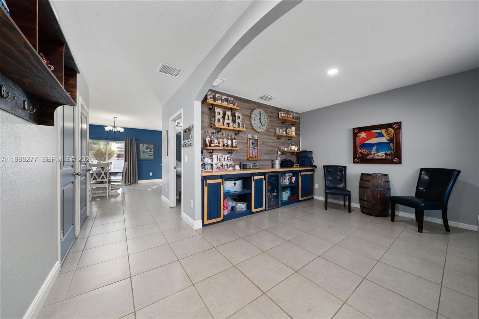 2824 Northeast 43rd Road Ocala, FL 34470 - Photo 4 of 45 a living room with lots of furniture and a refrigerator