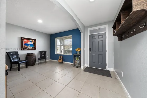 a view of a livingroom with furniture and a flat screen tv