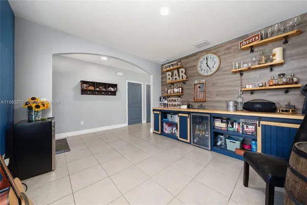 a living room with furniture cabinets and window
