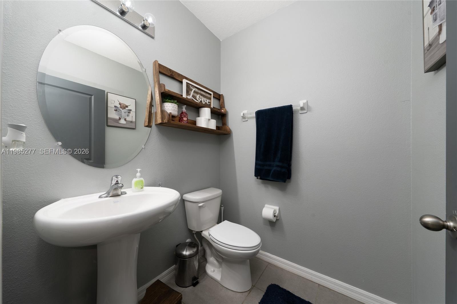2824 Northeast 43rd Road Ocala, FL 34470 - Photo 7 of 45 a bathroom with a toilet sink and mirror