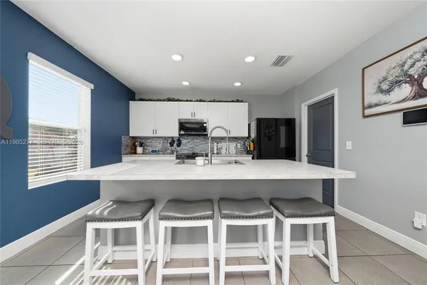 a view of a dining room with furniture and window