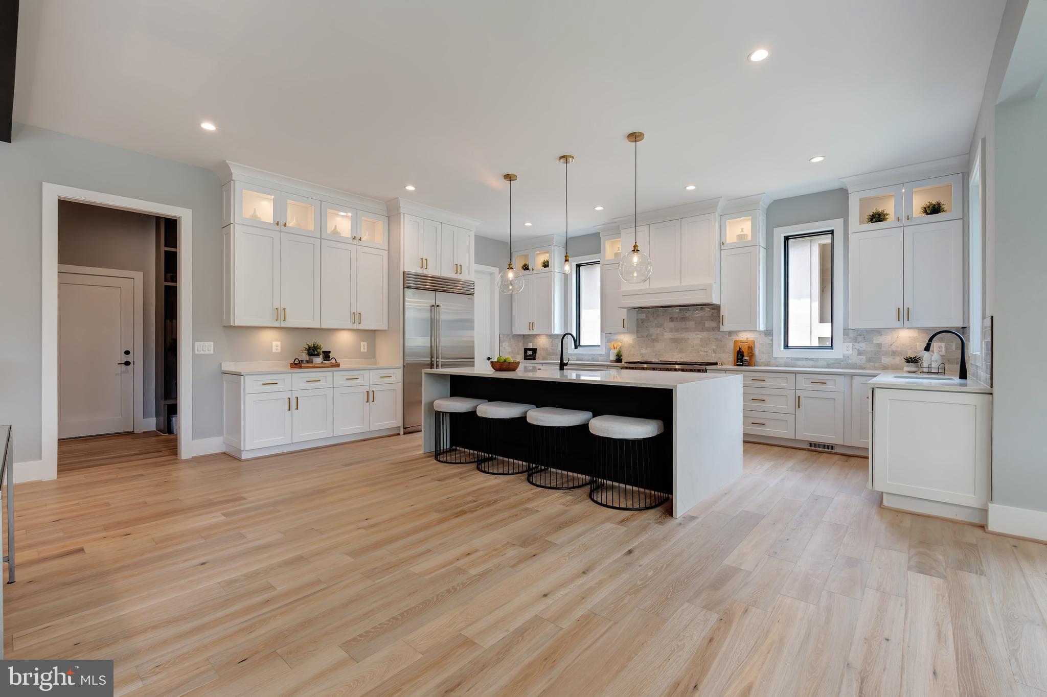 6800 Old Chesterbrook Road McLean, VA 22101 - Photo 14 of 44 a room with kitchen island granite countertop wooden floors and view living room