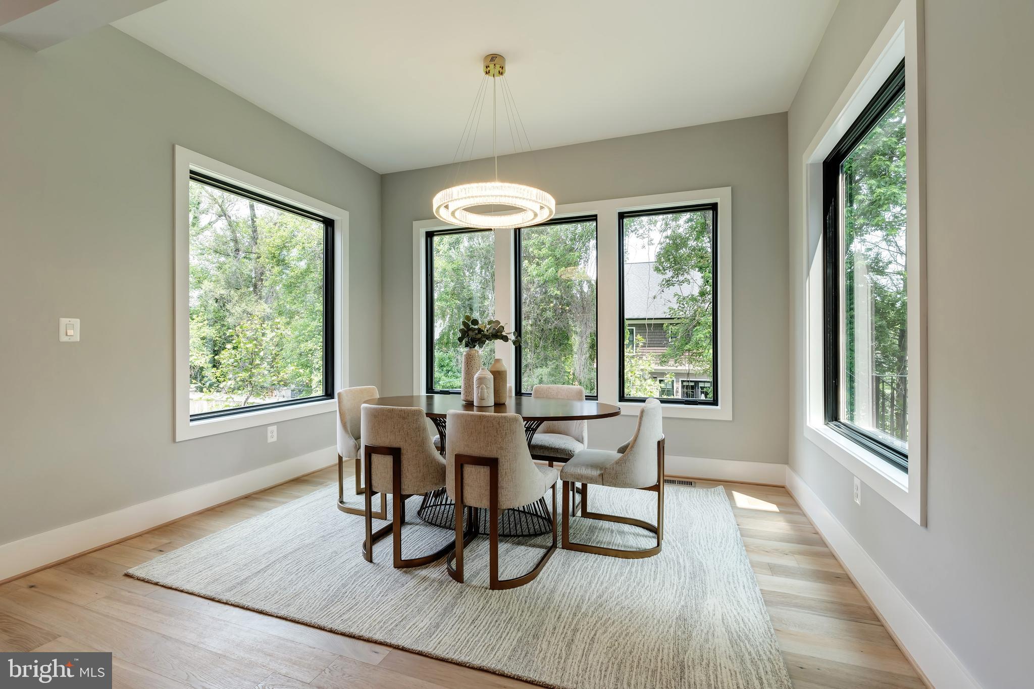 6800 Old Chesterbrook Road McLean, VA 22101 - Photo 17 of 44 a dining room with wooden floor glass table and chairs