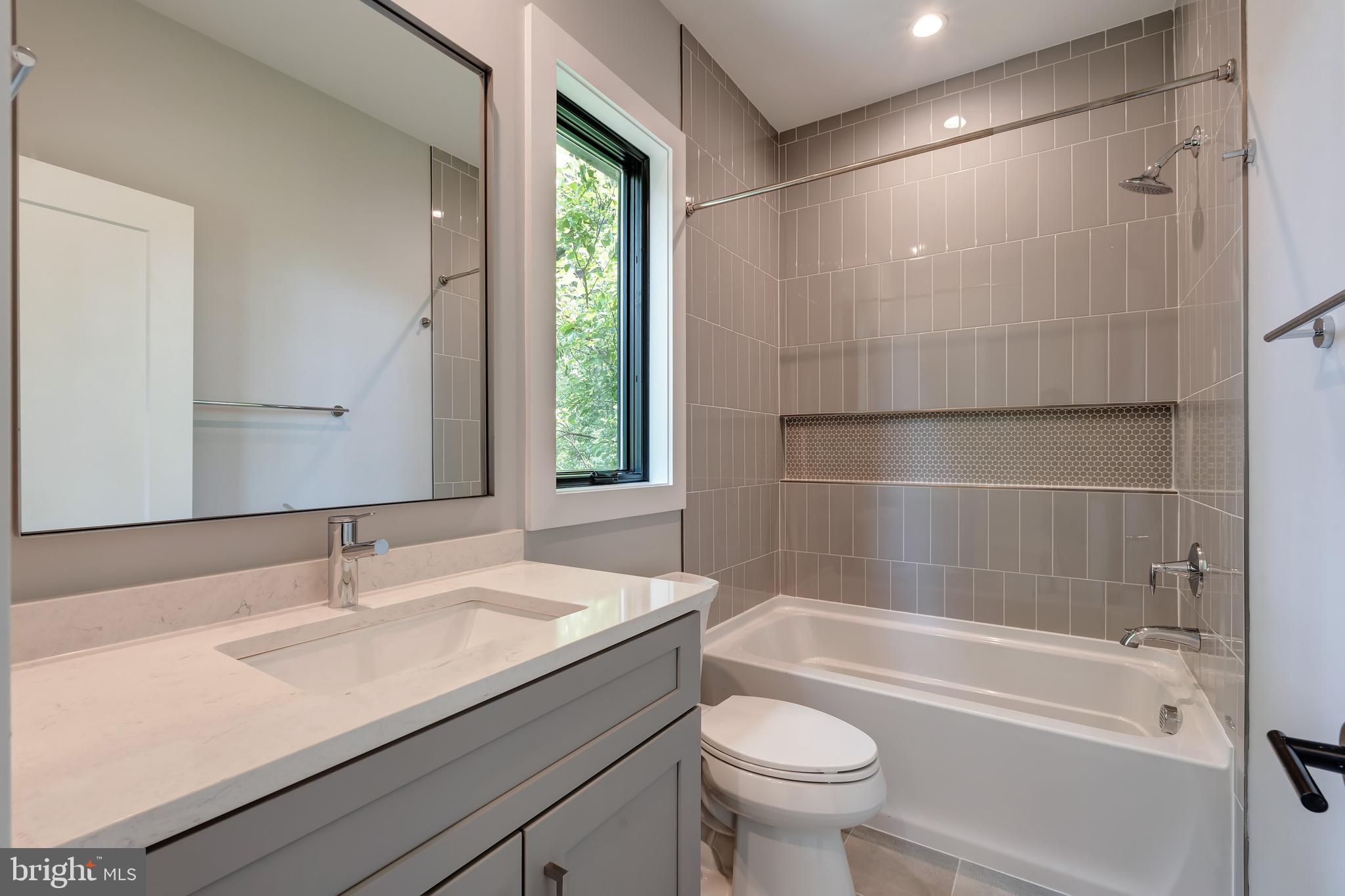 6800 Old Chesterbrook Road McLean, VA 22101 - Photo 22 of 44 a bathroom with a granite countertop sink a toilet and bathtub