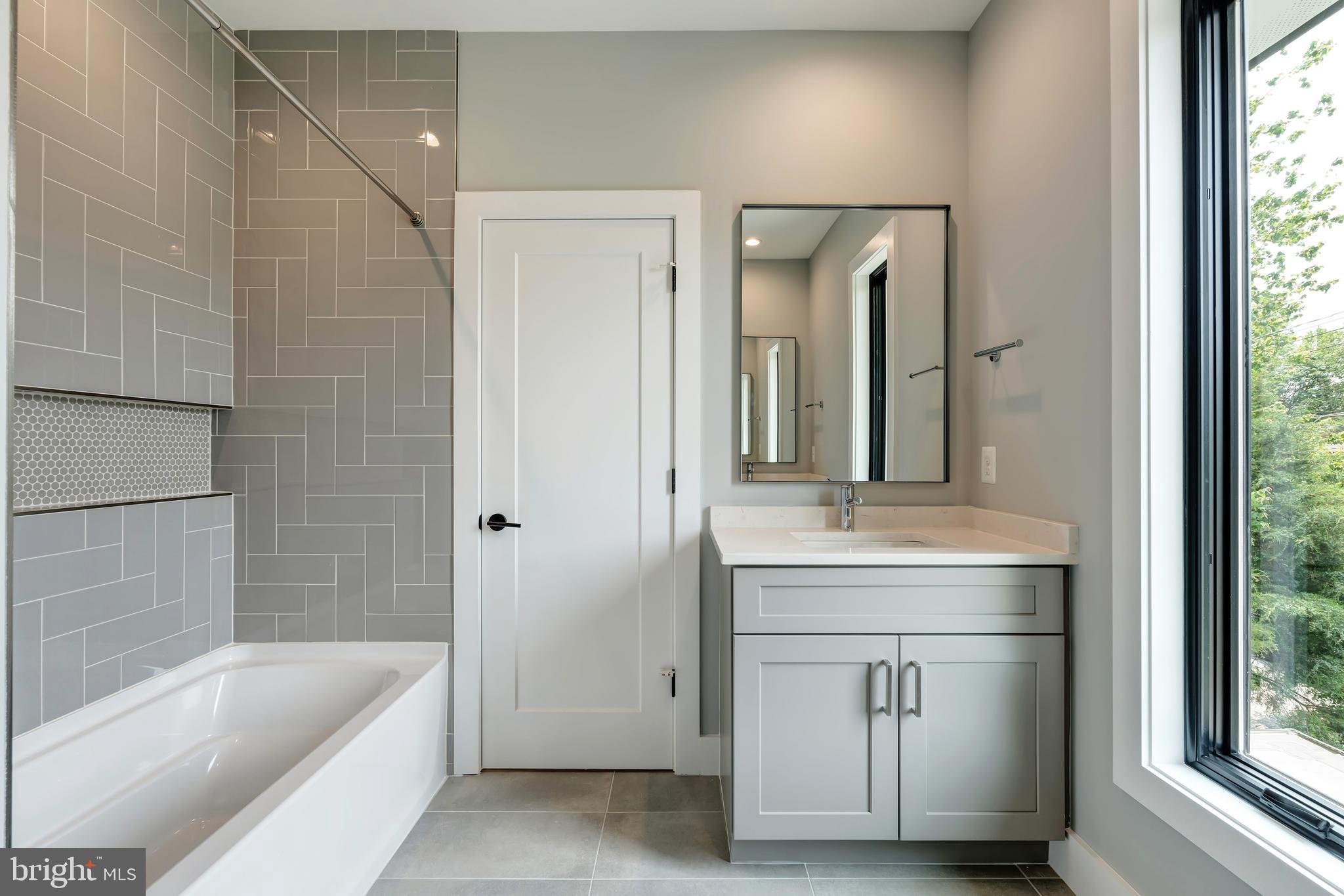 6800 Old Chesterbrook Road McLean, VA 22101 - Photo 25 of 44 a bathroom with a tub sink and mirror