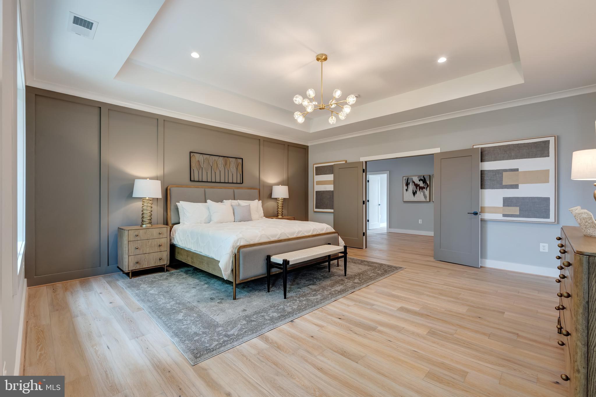 6800 Old Chesterbrook Road McLean, VA 22101 - Photo 30 of 44 a spacious bedroom with a bed and a chandelier