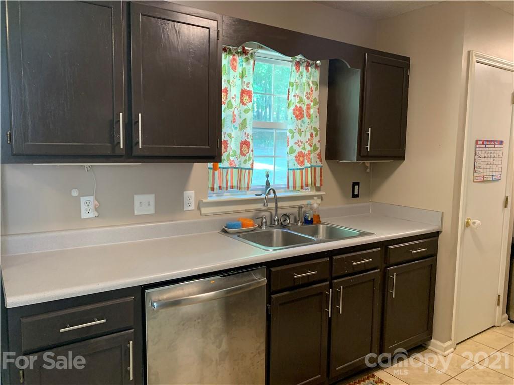 111 Creek View Road Mooresville, NC 28117 - Photo 11 of 25 a kitchen with a sink and a mirror