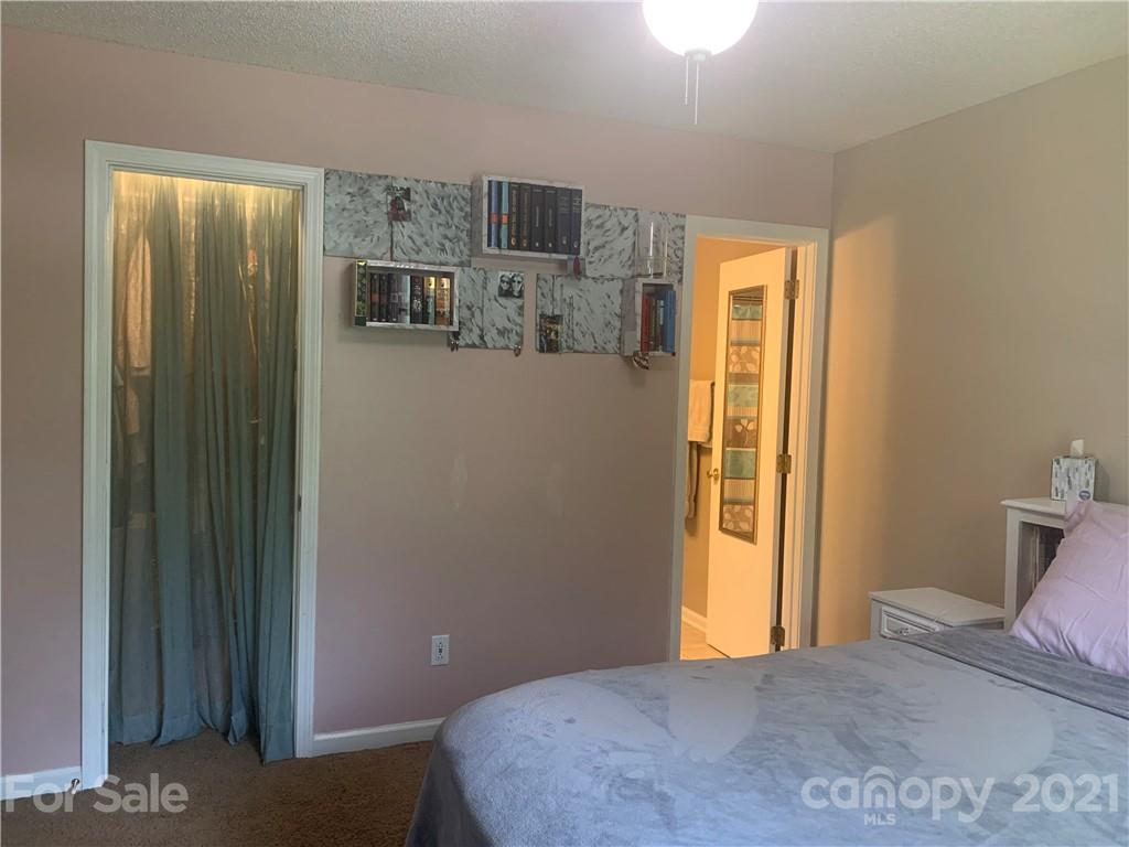 111 Creek View Road Mooresville, NC 28117 - Photo 15 of 25 a bedroom with a bed and wooden floor