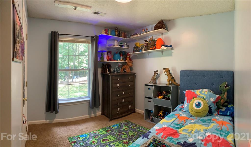 111 Creek View Road Mooresville, NC 28117 - Photo 22 of 25 a bedroom with baby toys and dresser