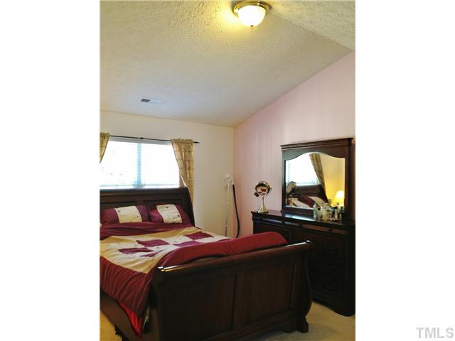 4113 Palafox Court Raleigh, NC 27604 - Photo 17 of 25 a bedroom with a bed and window