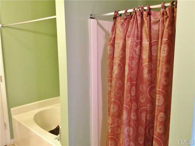 4113 Palafox Court Raleigh, NC 27604 - Photo 19 of 25 a bathroom with a shower curtain and a curtain