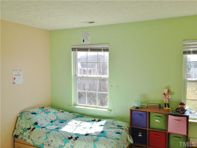 4113 Palafox Court Raleigh, NC 27604 - Photo 21 of 25 a bedroom with a bed and window