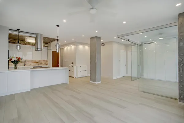 a view of large kitchen with stainless steel appliances cabinets